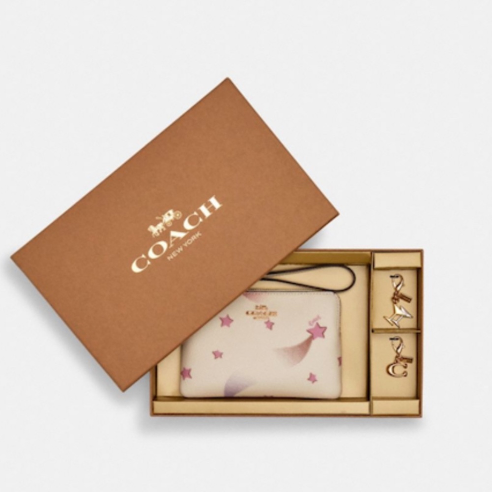 NWT Coach Wristlet with Charms in Box